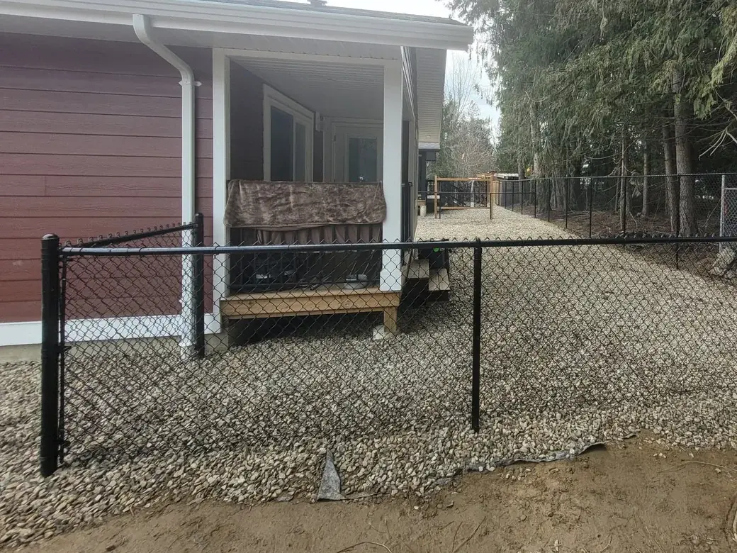 Black chain link fence around a residential yard